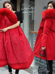 Two women wearing red fur-lined coats in front of a store entrance.