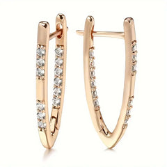 Rose gold hoop earrings with diamond accents on a white background