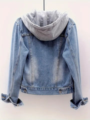 Blue denim jacket with gray hood on a light pink background