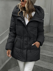 Person wearing a black puffer jacket on a staircase