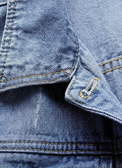 Close-up of a blue denim jacket with stitching details