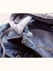 Close-up of a blue denim jacket with a button and zipper detail.