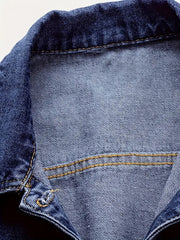 Close-up of a blue denim jacket with stitching detail