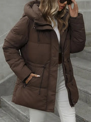 Person wearing a brown puffer jacket on a staircase