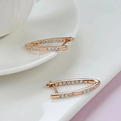 Rose gold earring with clear stones on a white background