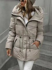 Person wearing a beige puffer jacket on a staircase