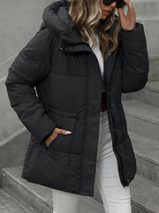 Person wearing a black puffer jacket on a staircase