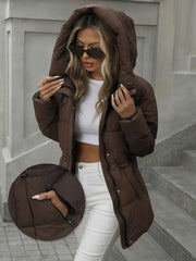 Woman wearing a brown hooded coat with a close-up inset, standing on steps.