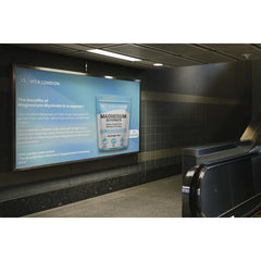 Woman holding Magnesium Glycinate UK supplement for natural sleep and stress relief
